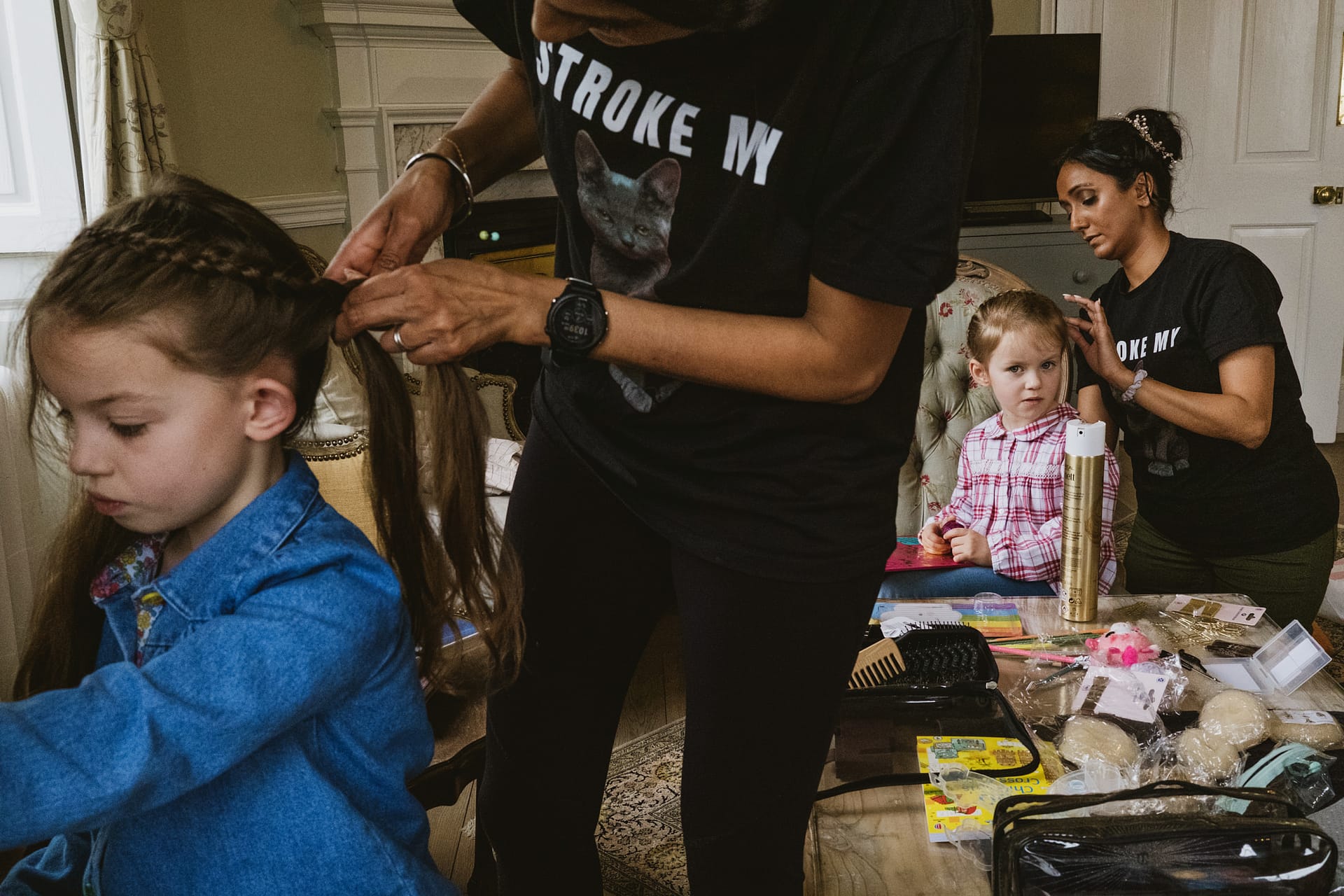 Children having hair styled indoors.