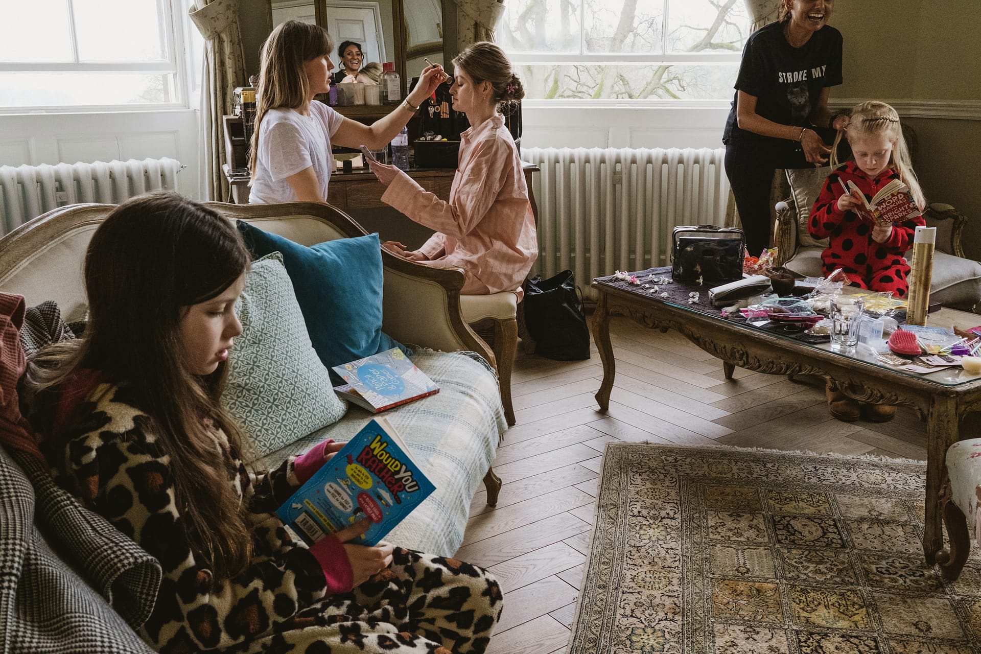 Children reading while getting ready in lounge.
