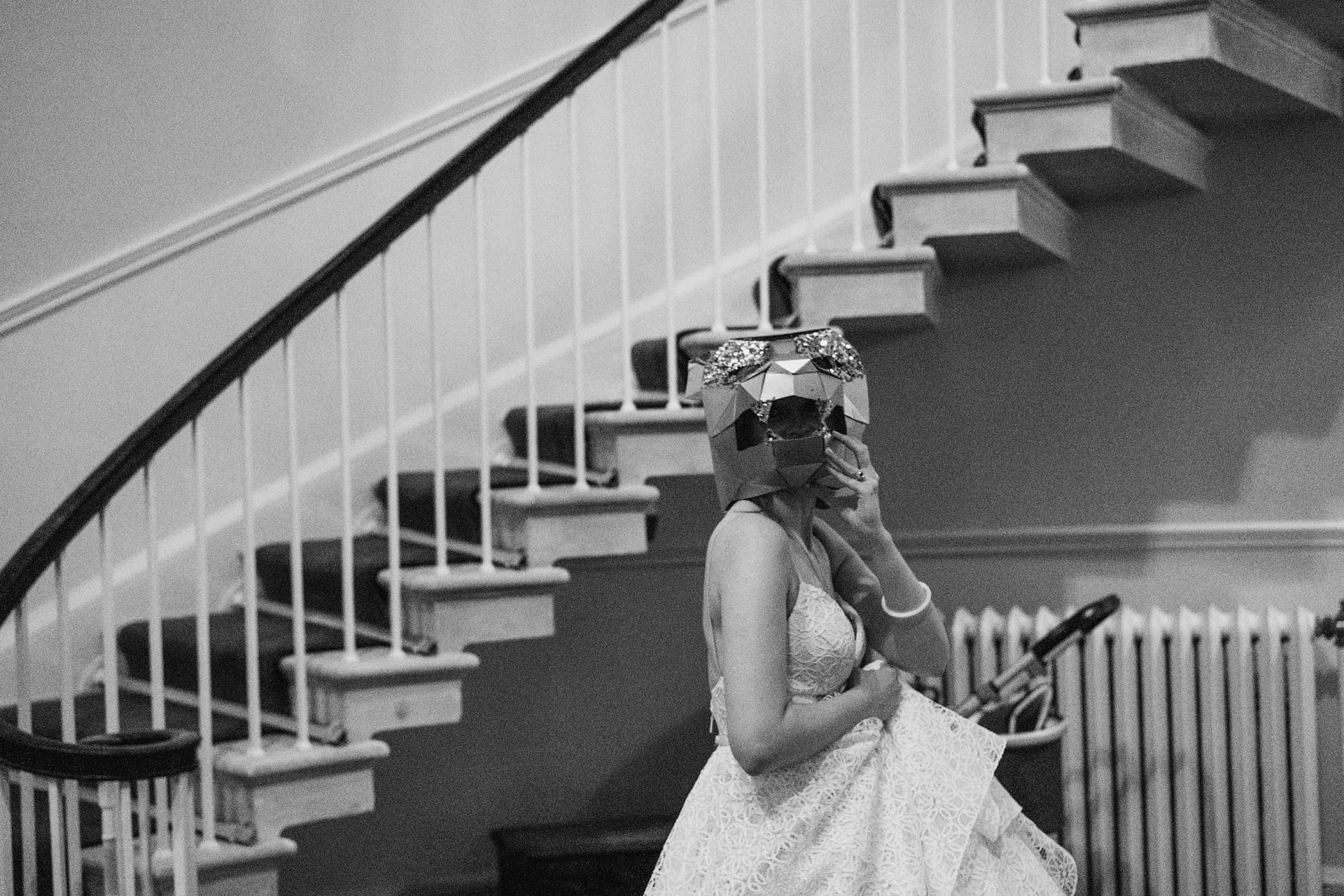 Person in mask on staircase in black and white
