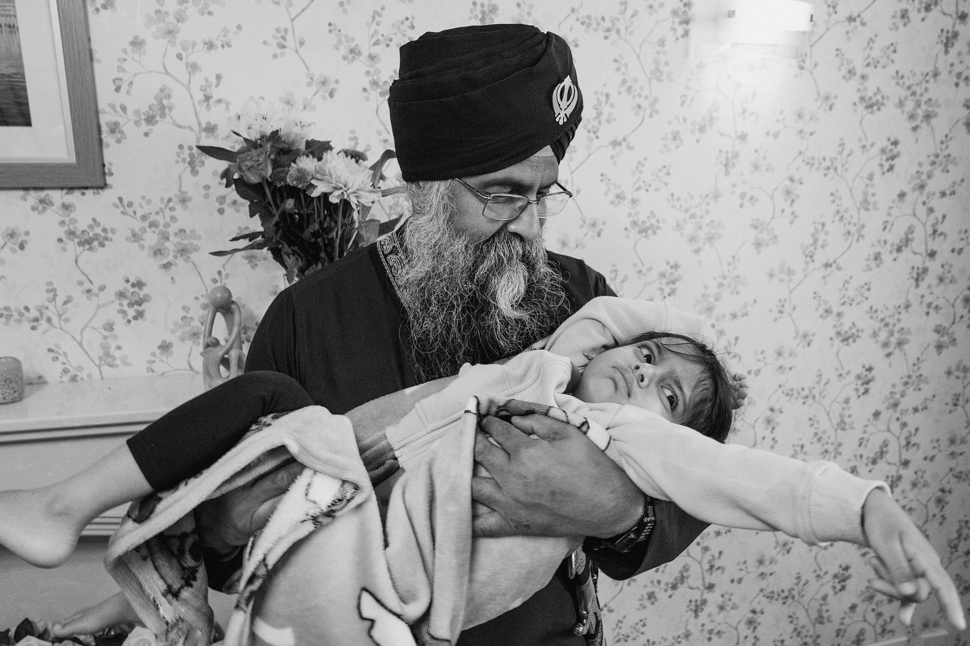 Man holding child in traditional attire