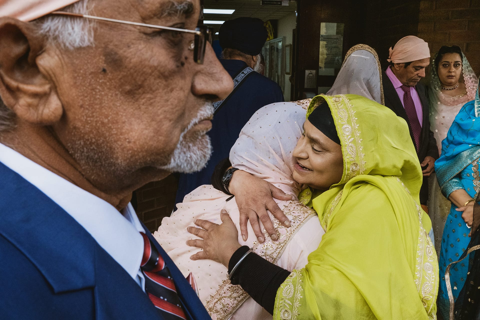 Group of people embracing at joyful gathering.