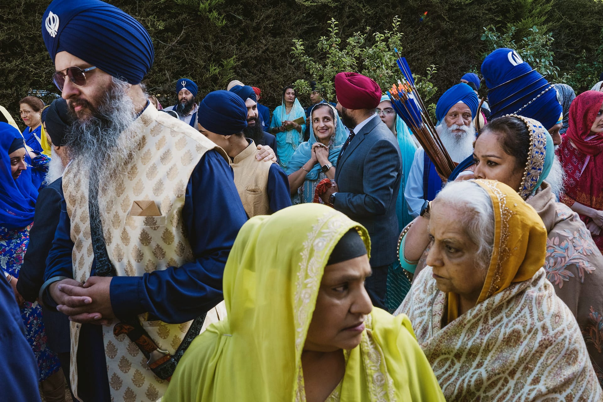 Sikh gathering with people in colourful traditional attire.