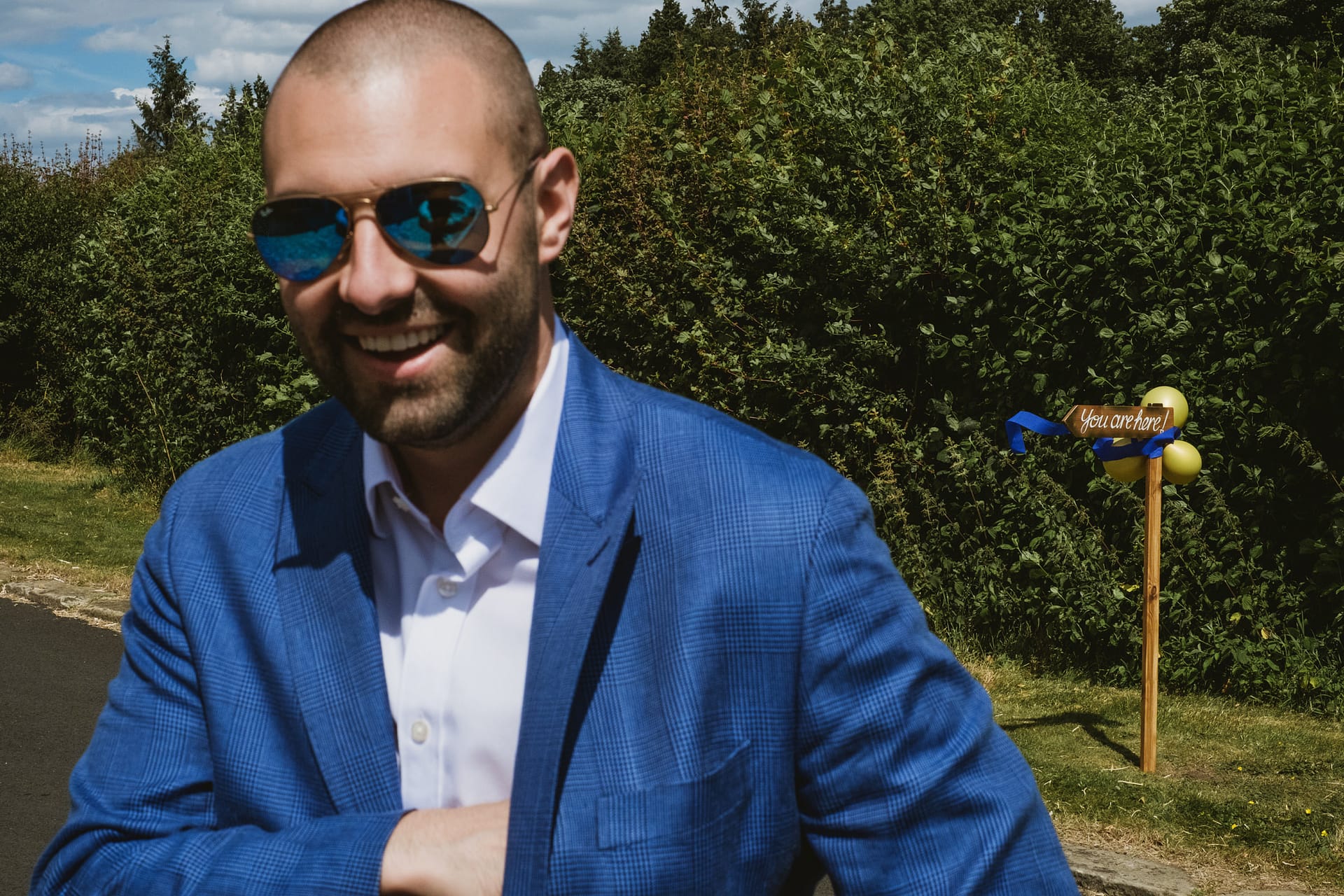 Smiling man in blue suit outdoors