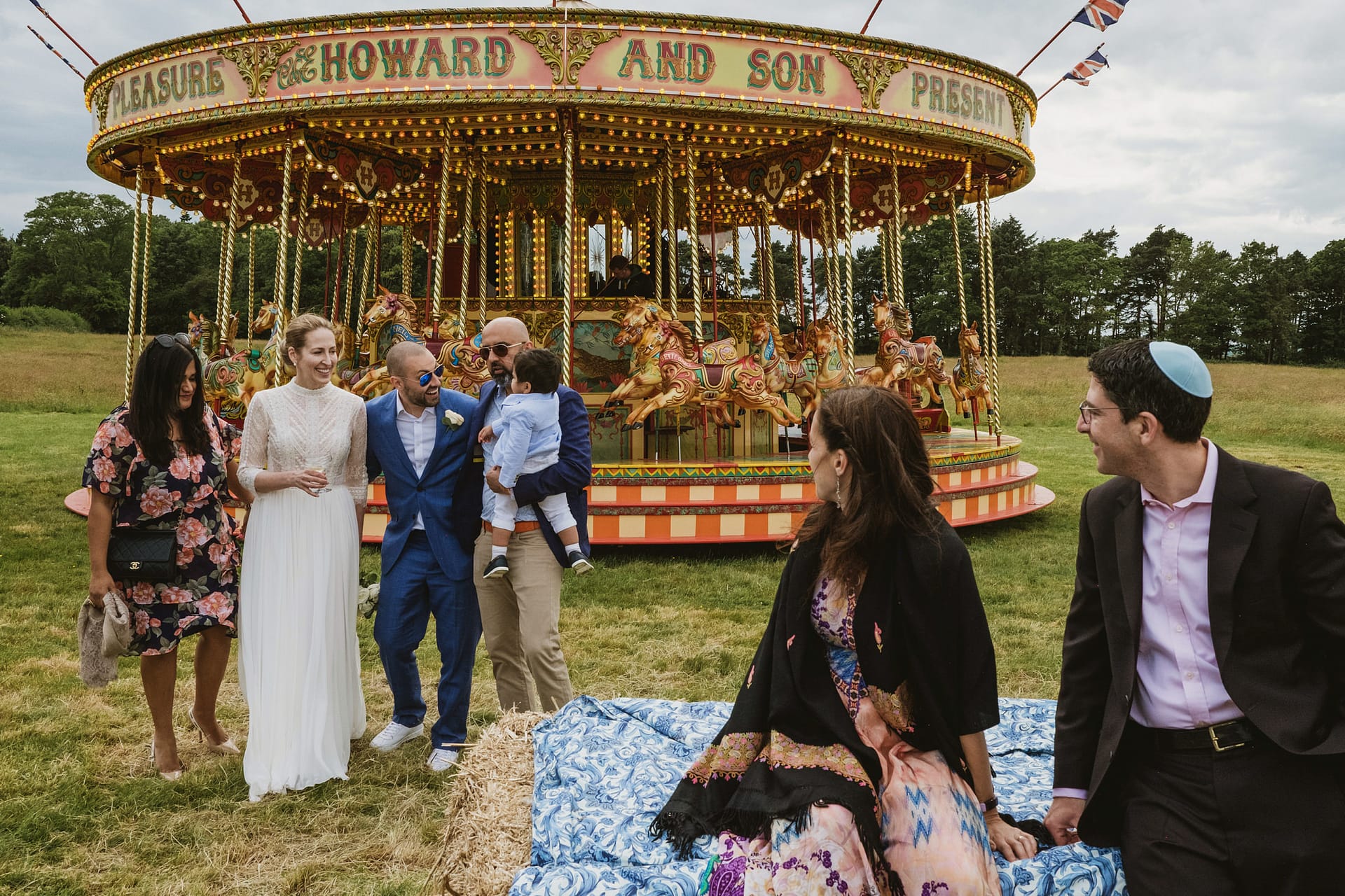 People enjoying wedding near vintage carousel
