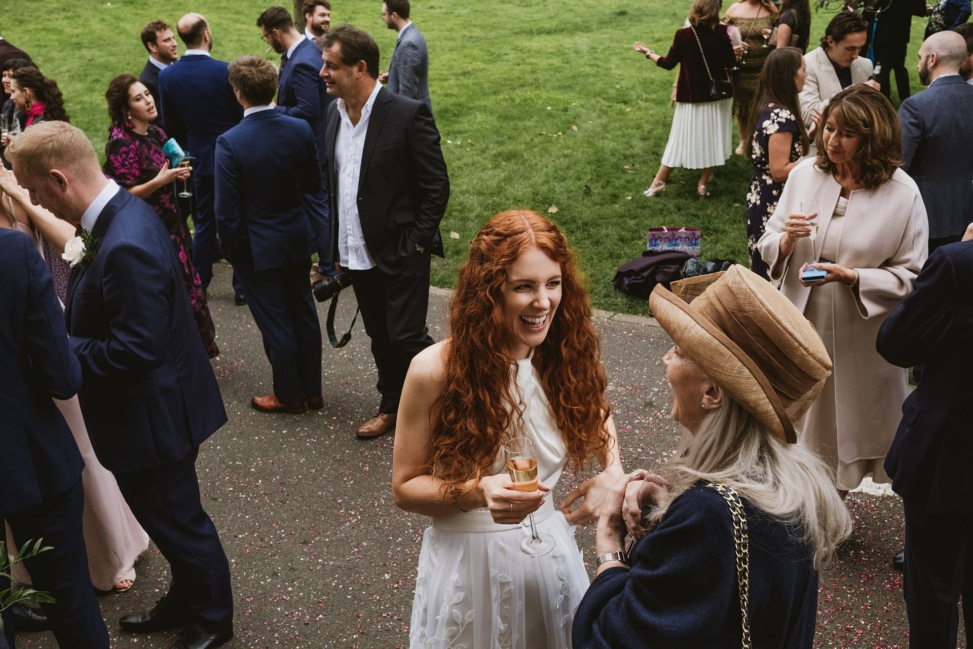 bride chatting with wedding guests outside the asylum chapel