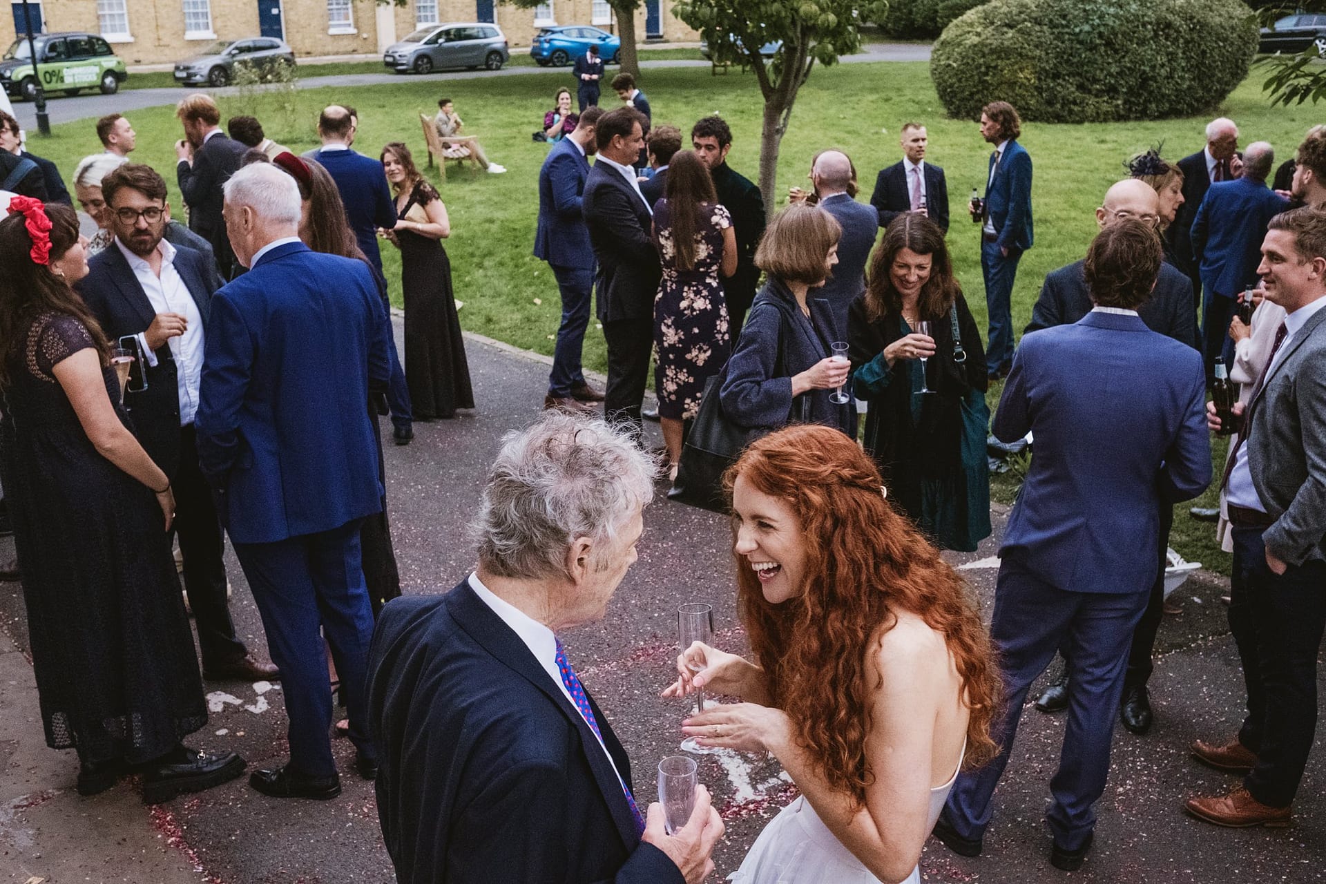 bride chatting with wedding guests outside the asylum chapel
