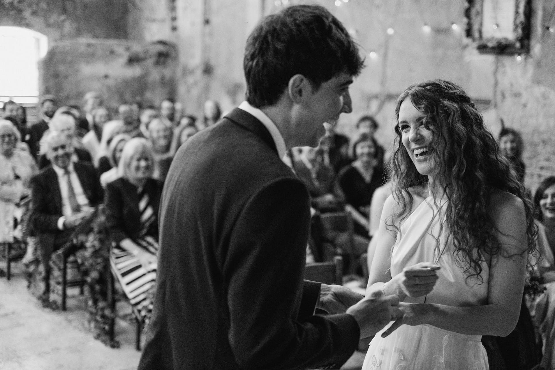 bride and groom exchanging wedding rings at asylum chapel