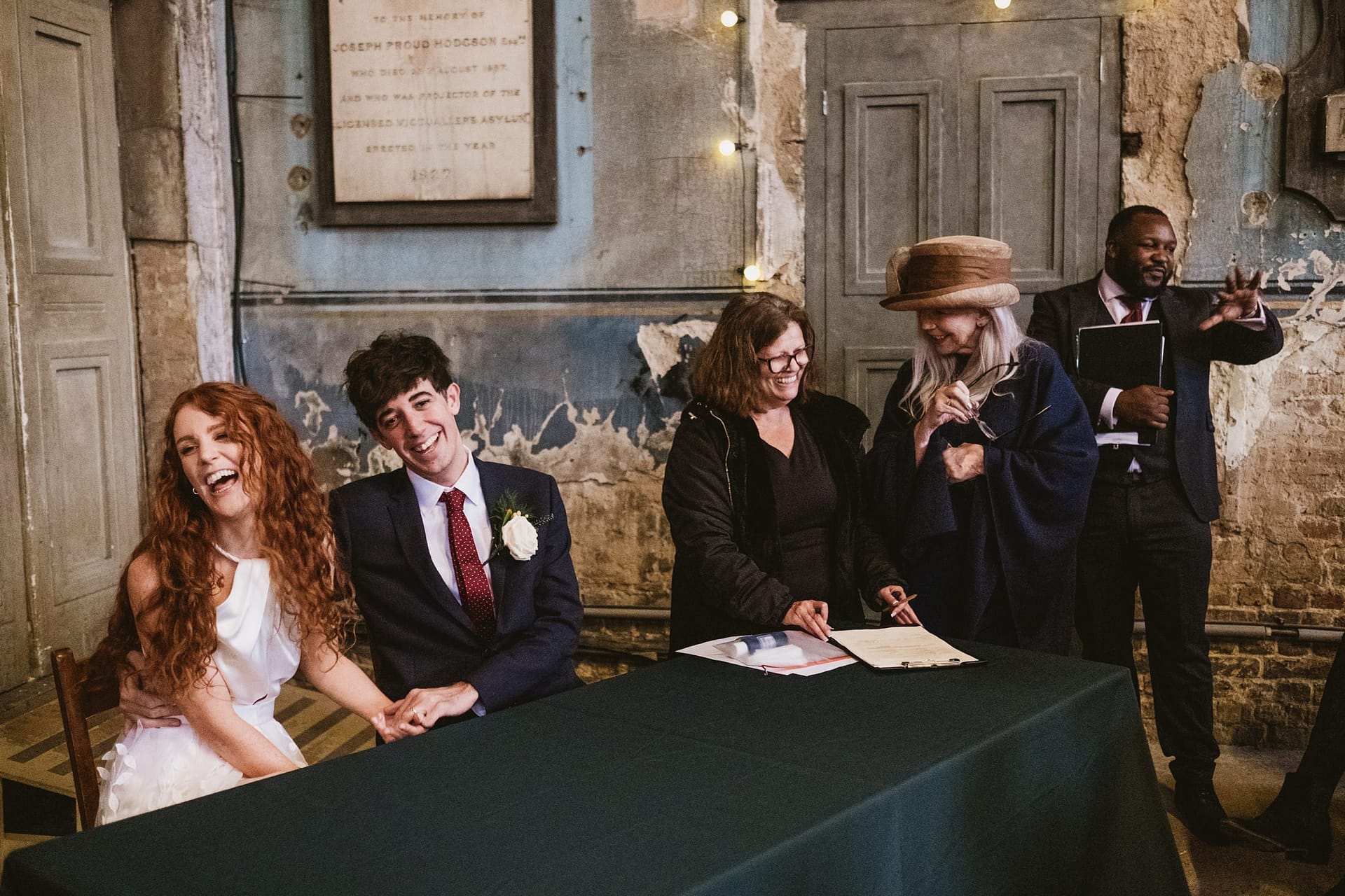 bride and groom signing the registry at asylum chapel