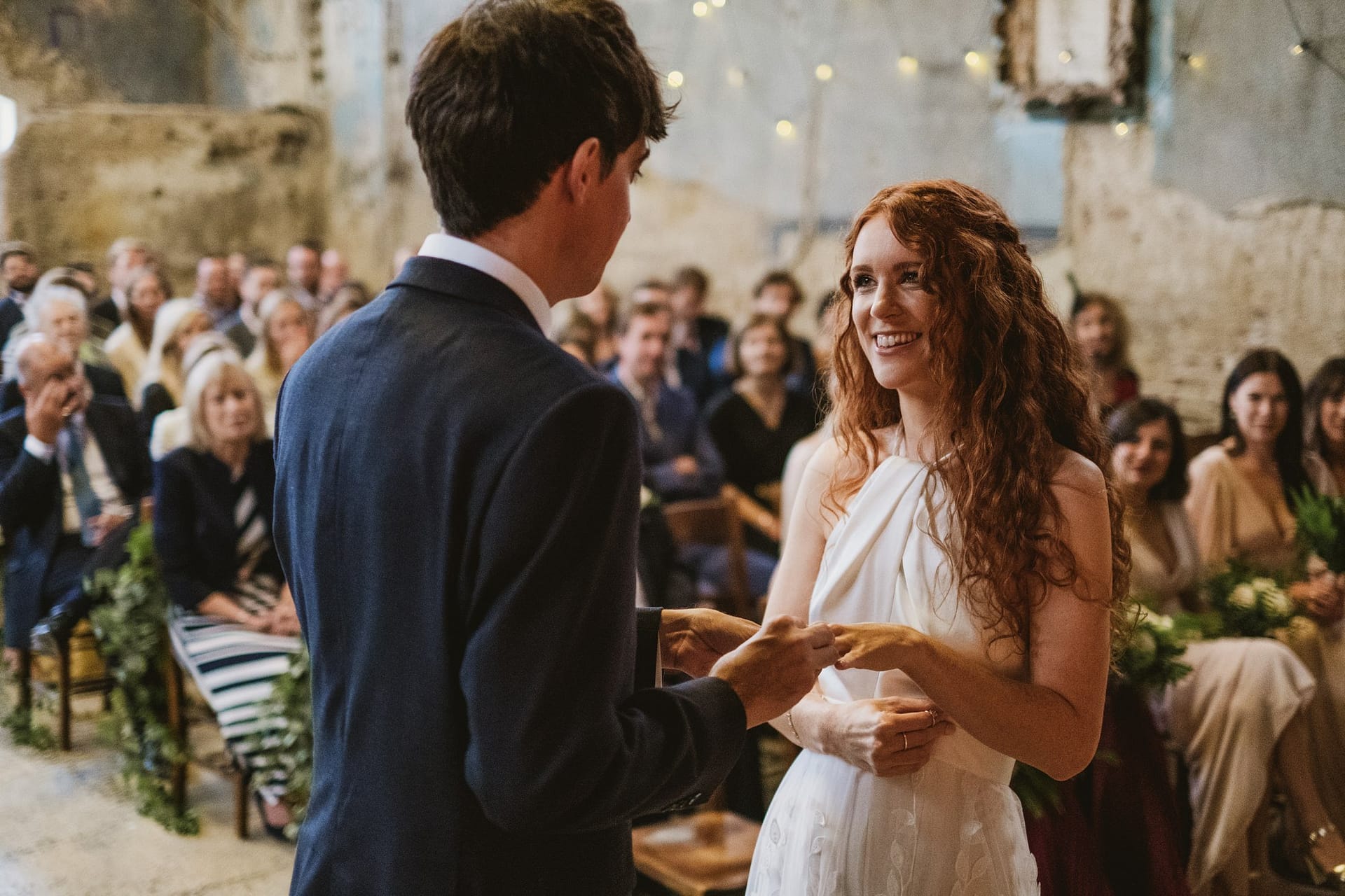 bride and groom exchanging wedding rings at asylum chapel