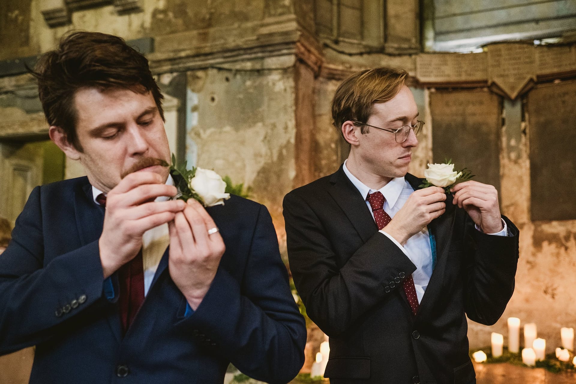 groomsmen putting on their button holes at asylum chapel