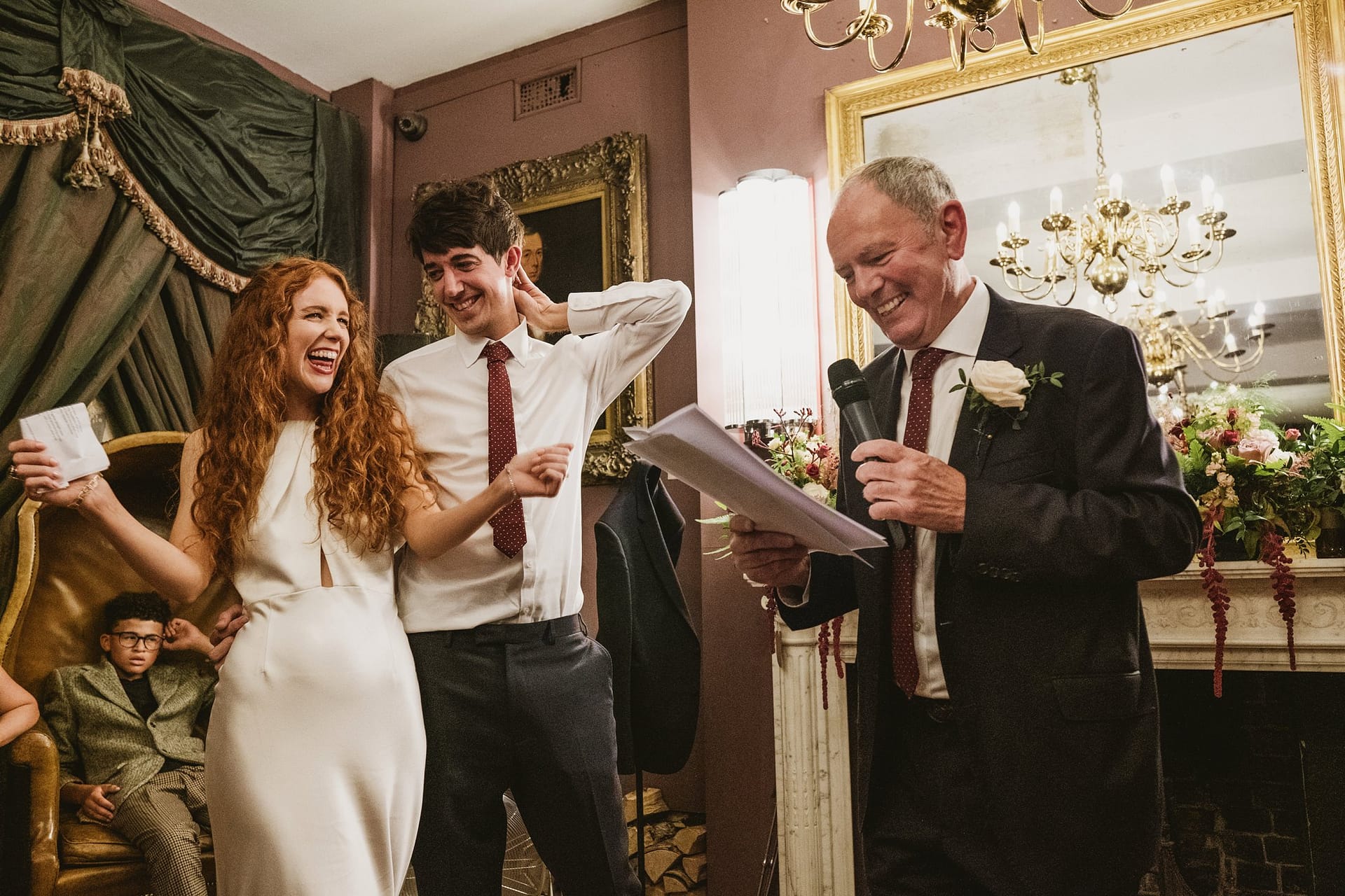 bride and groom listening to father of the bride speech