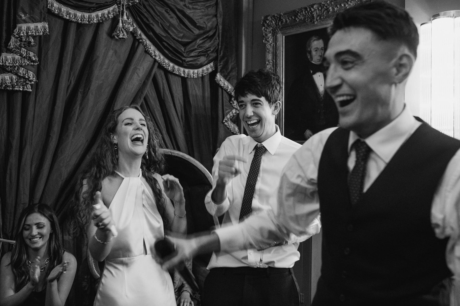 bride and groom laughing at best man speech