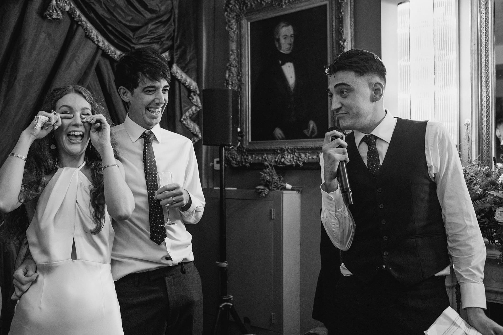 bride and groom laughing at best man speech