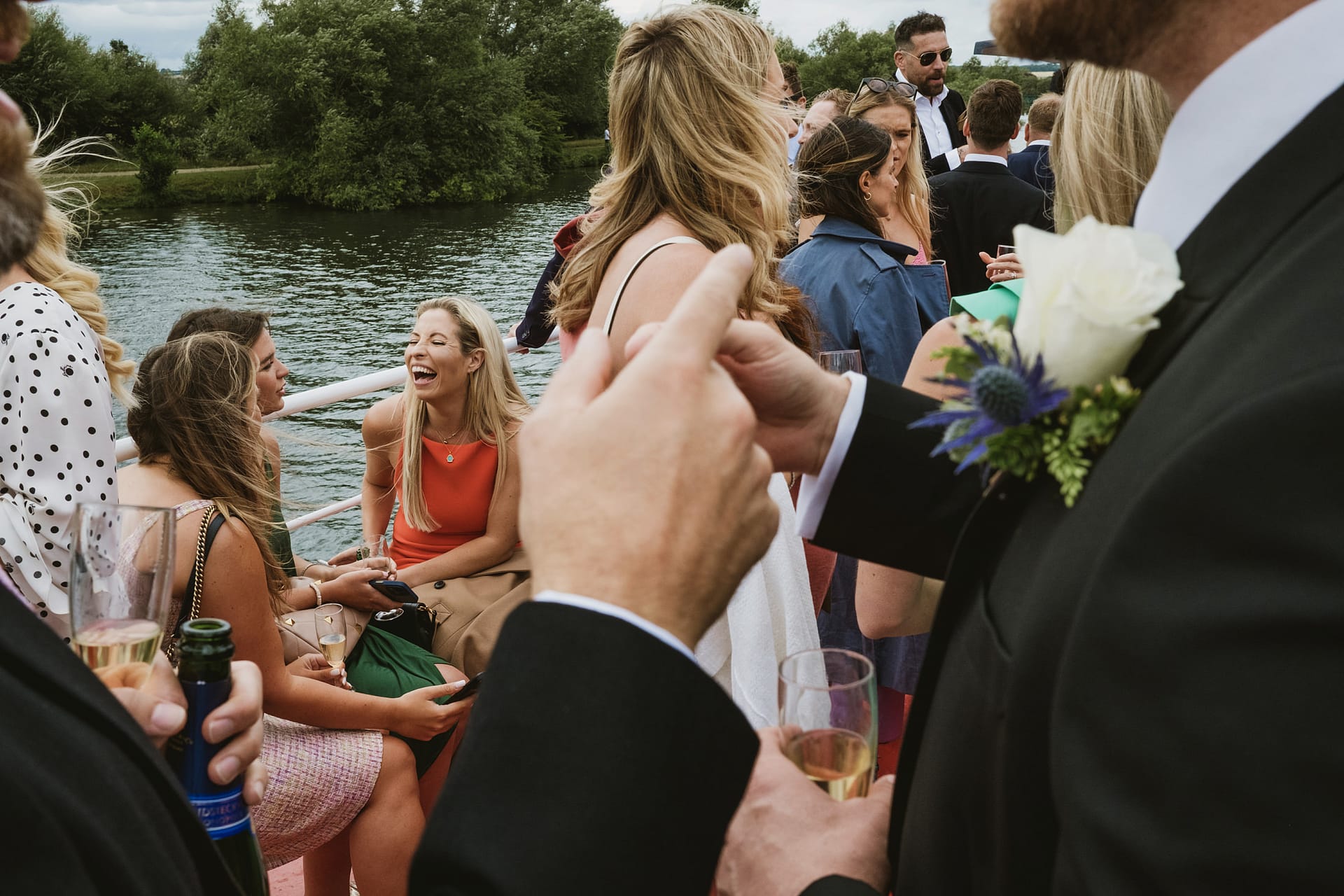 People laughing and chatting at outdoor event.