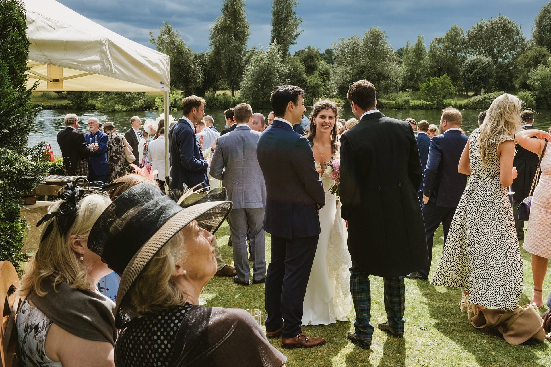 Guests socialising at an outdoor summer wedding