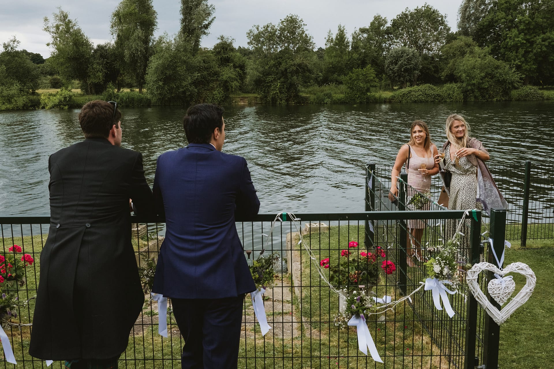 Two men and two women by a river.