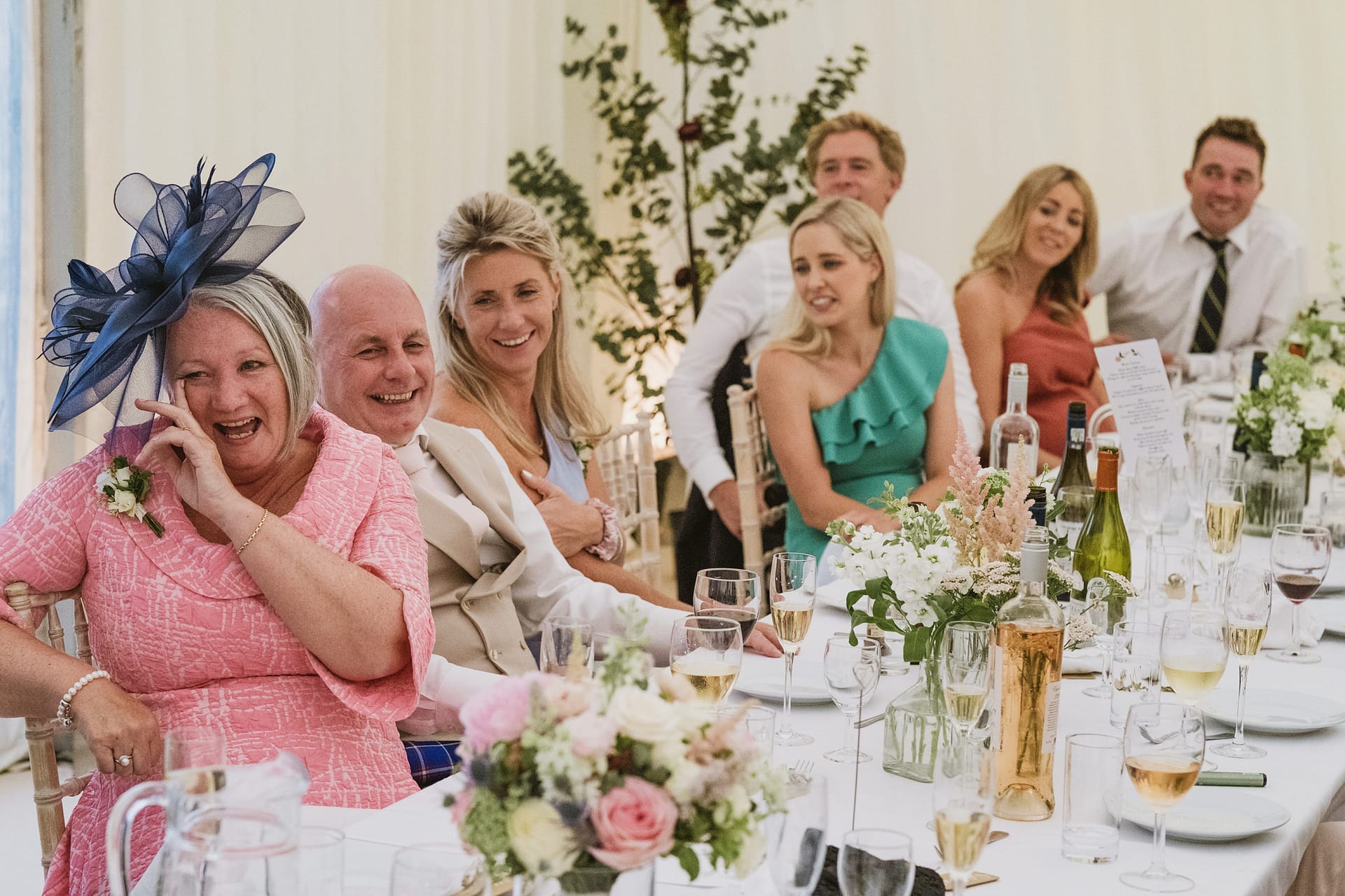 Guests laughing at wedding reception.