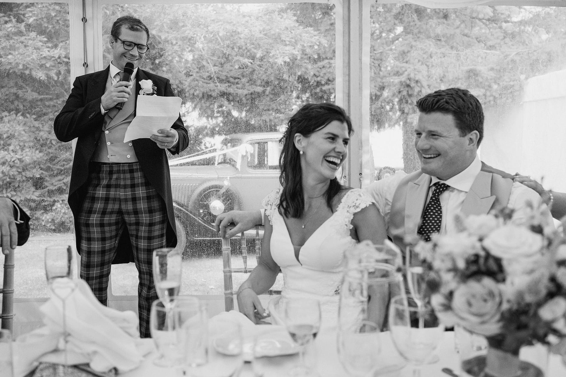Wedding speech with bride and groom laughing