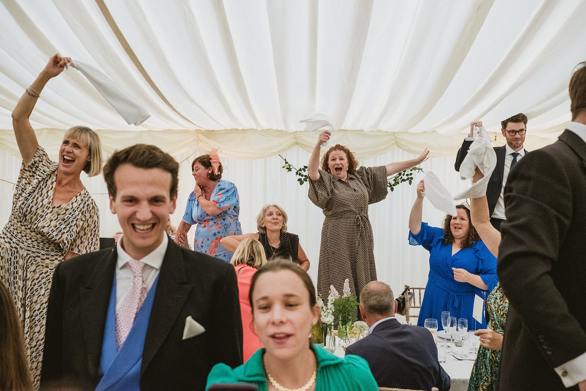 Guests celebrating at a wedding reception.