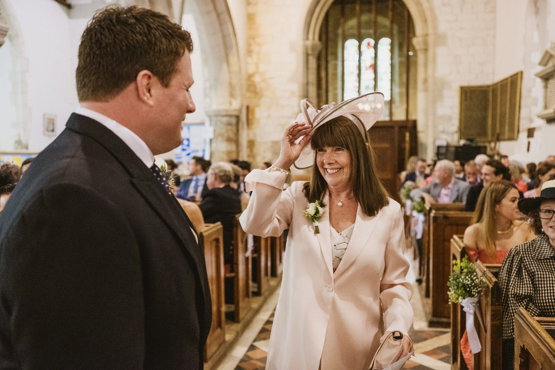 Smiling guests at wedding ceremony in church