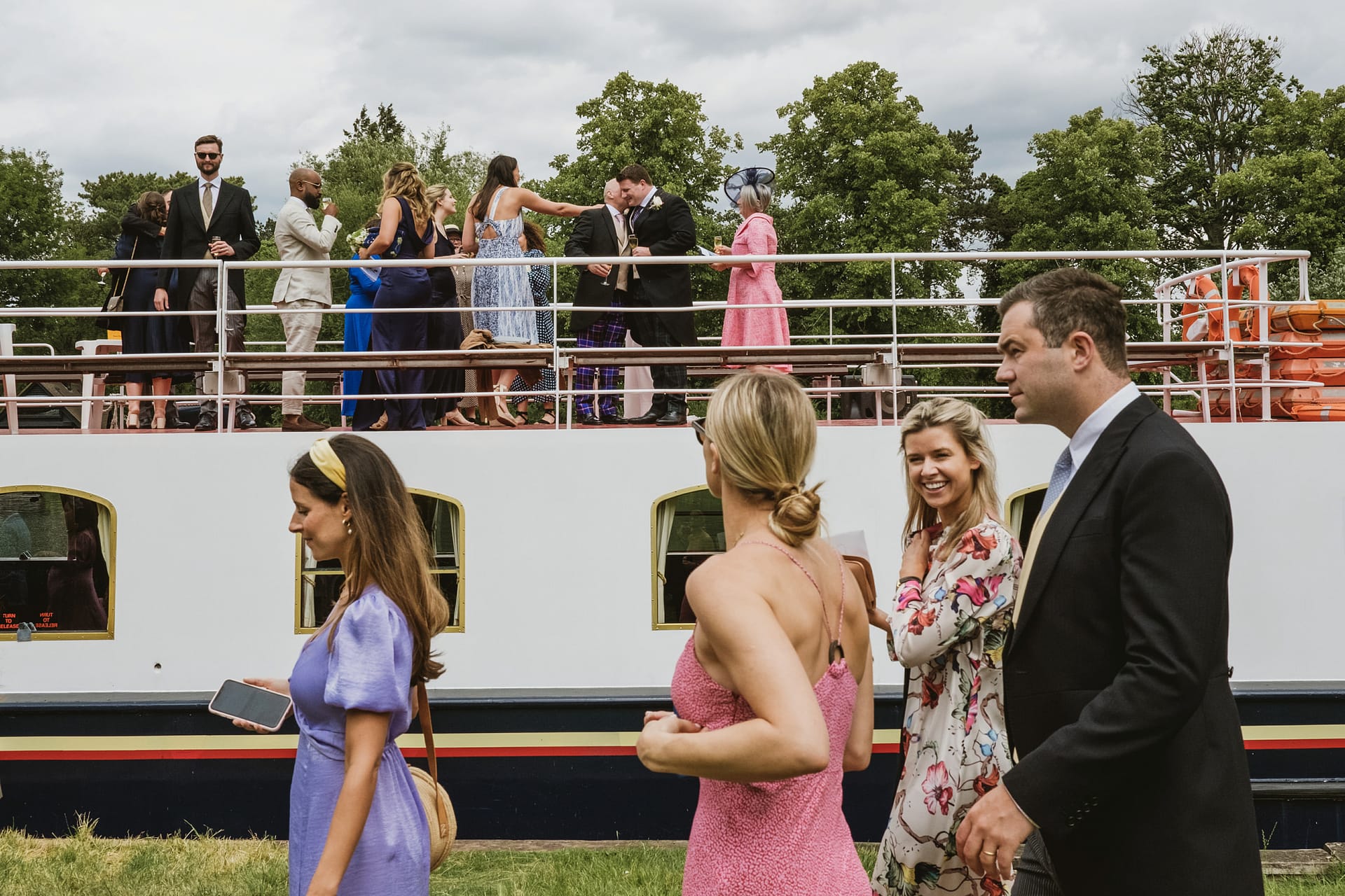 People socialising on a boat on a cloudy day.