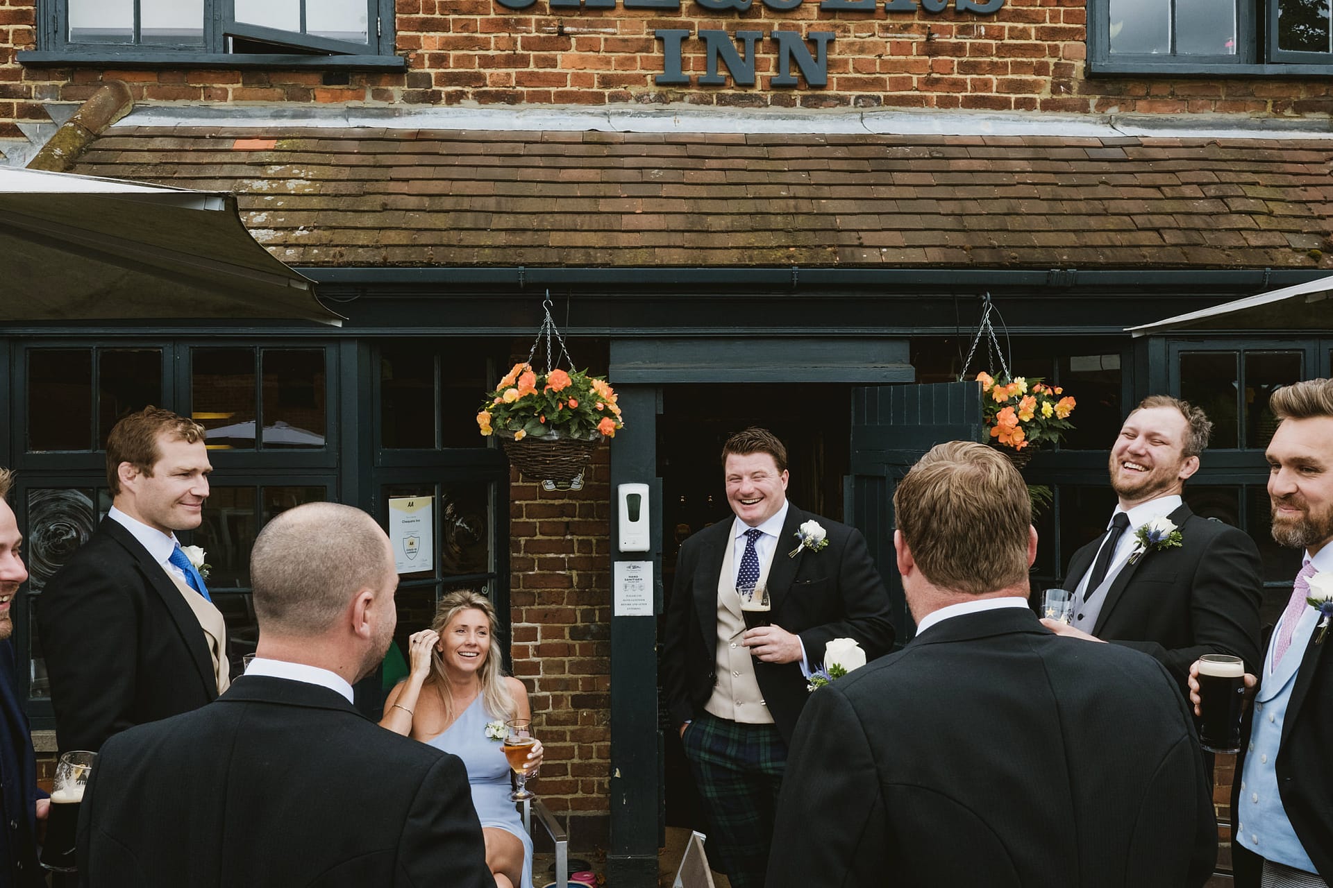 groom and groom's friends share a laugh together at the local pub in Buckinghamshire
