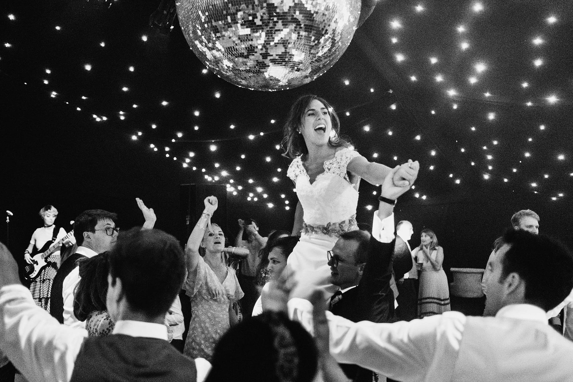 bride on dance floor being lifted into the air