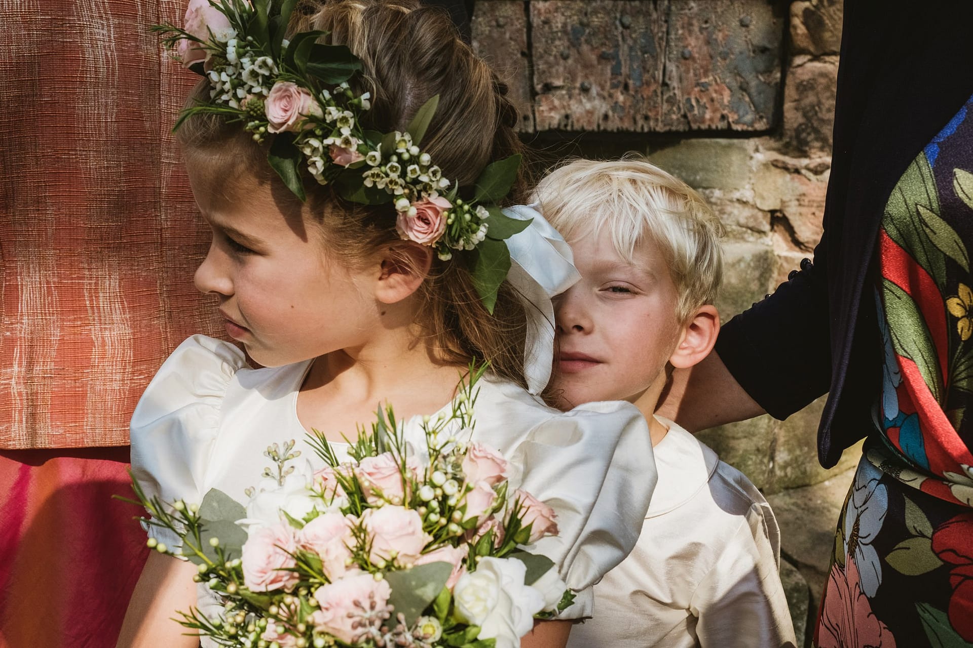 Cheshire wedding at church, page boy hiding behind flower girl