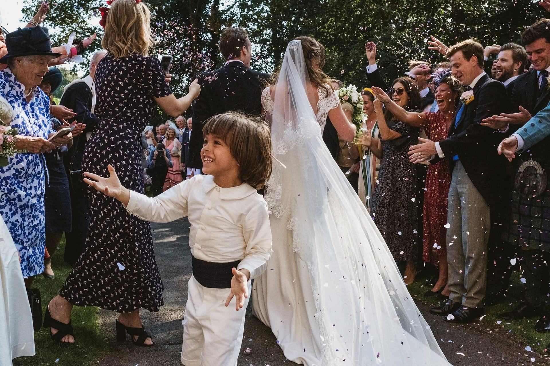 bride and groom running through confetti