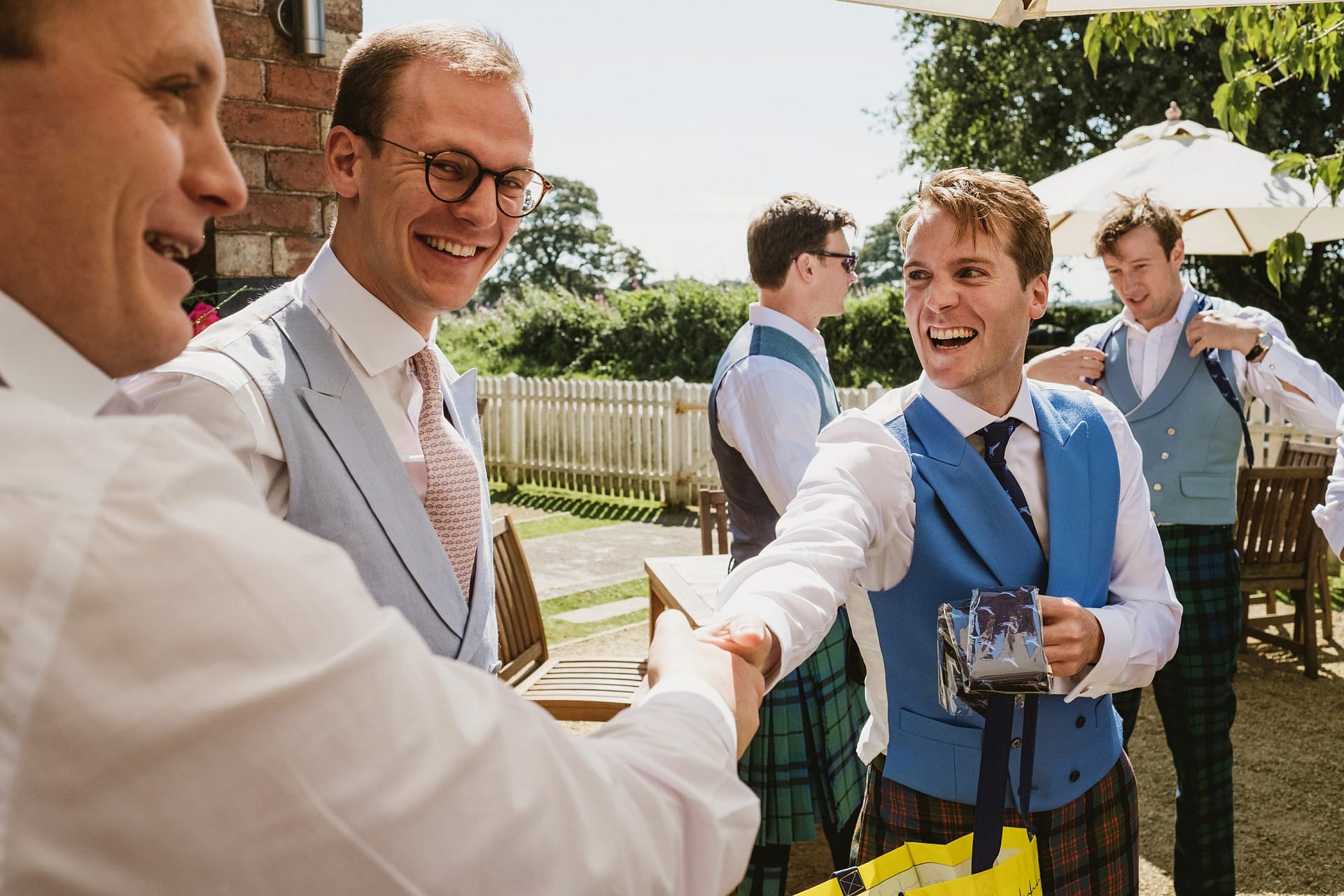 groom shaking hands with groomsmen at a Cheshire pub