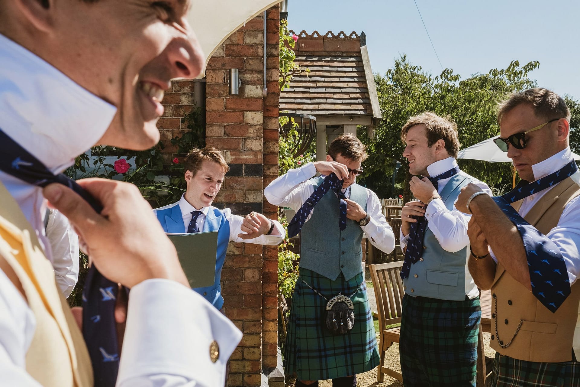 groom and groomsmen getting ready outside at the pub