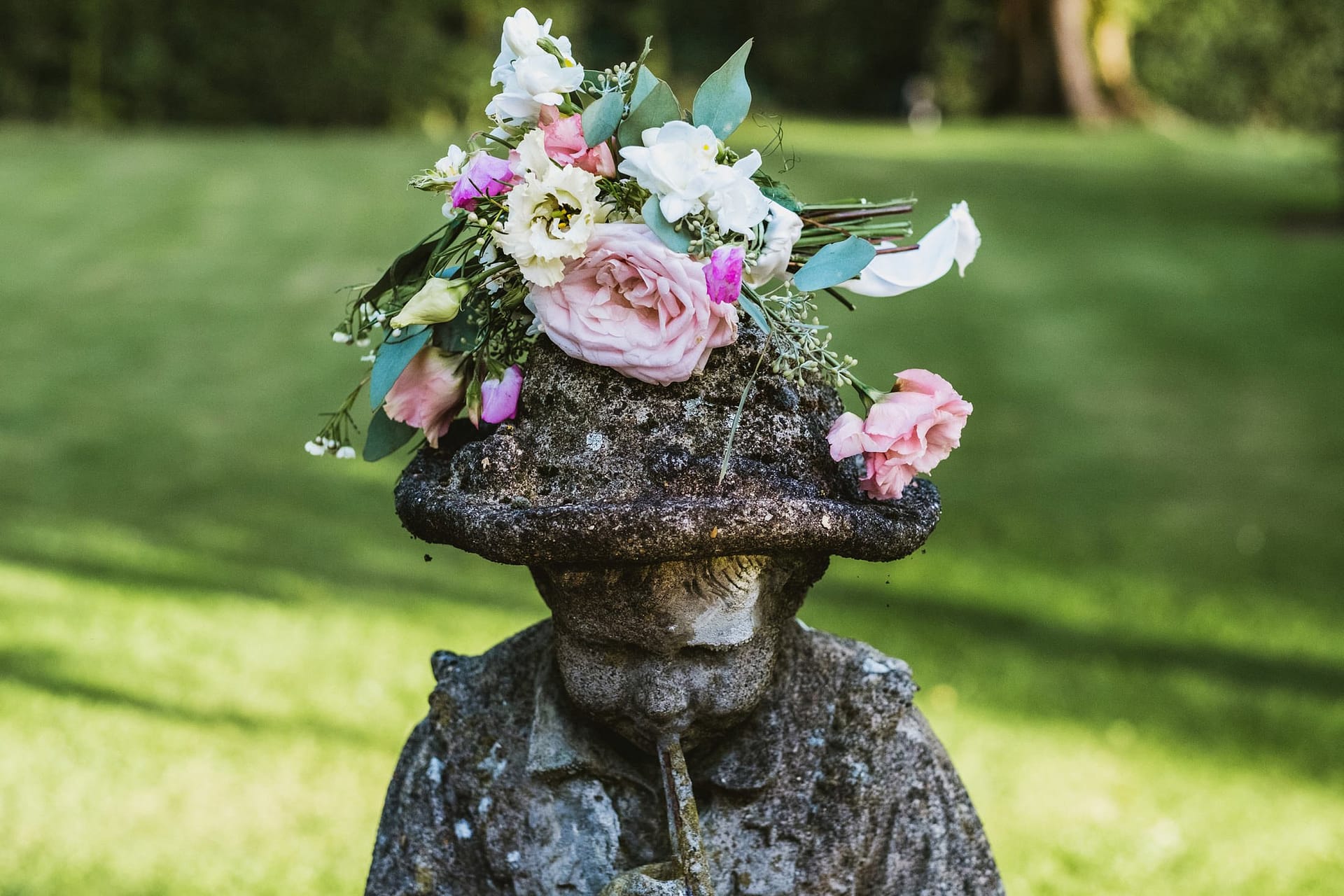 flowers being left on top of a statue