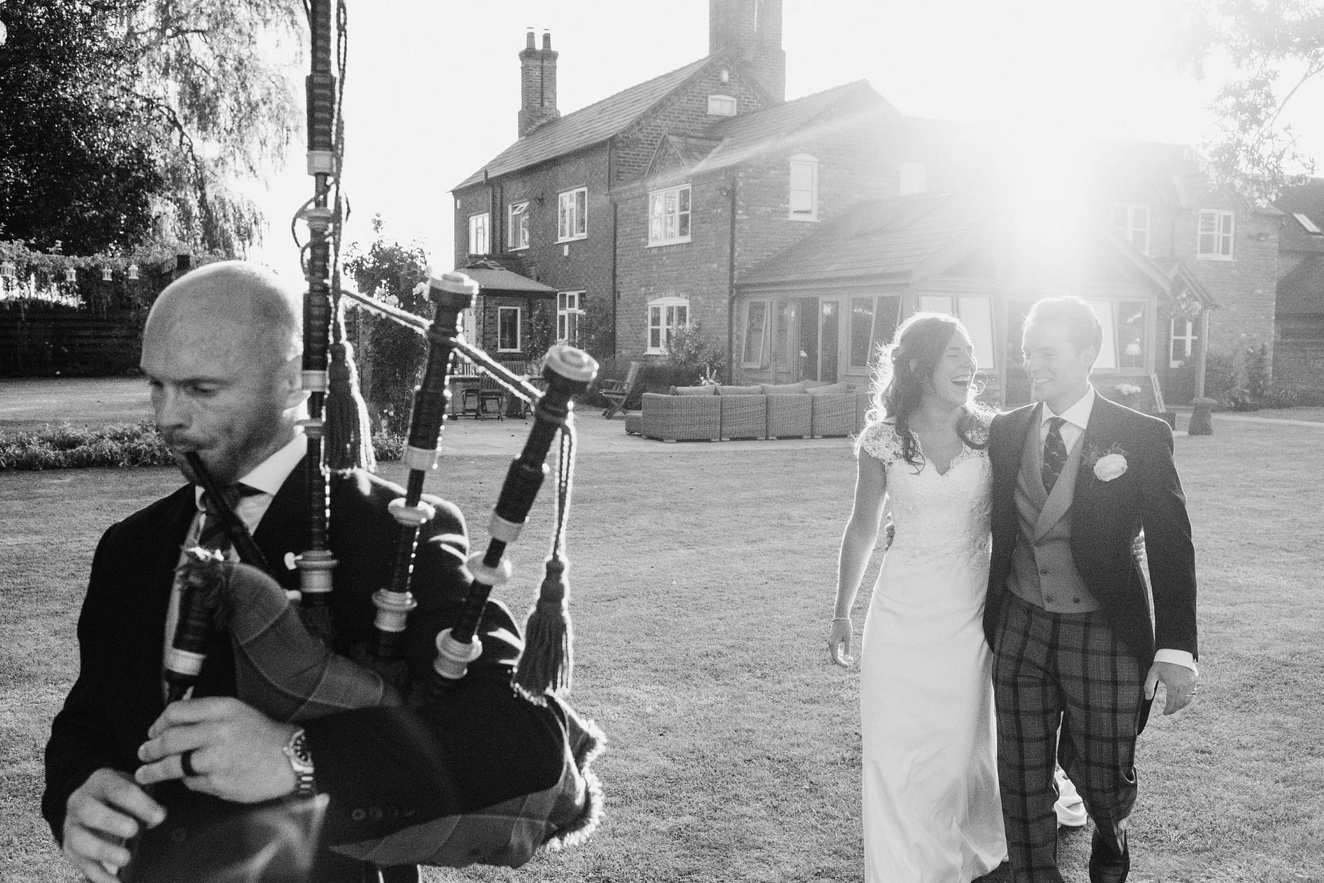 bride and groom wedding entrance with bagpipes