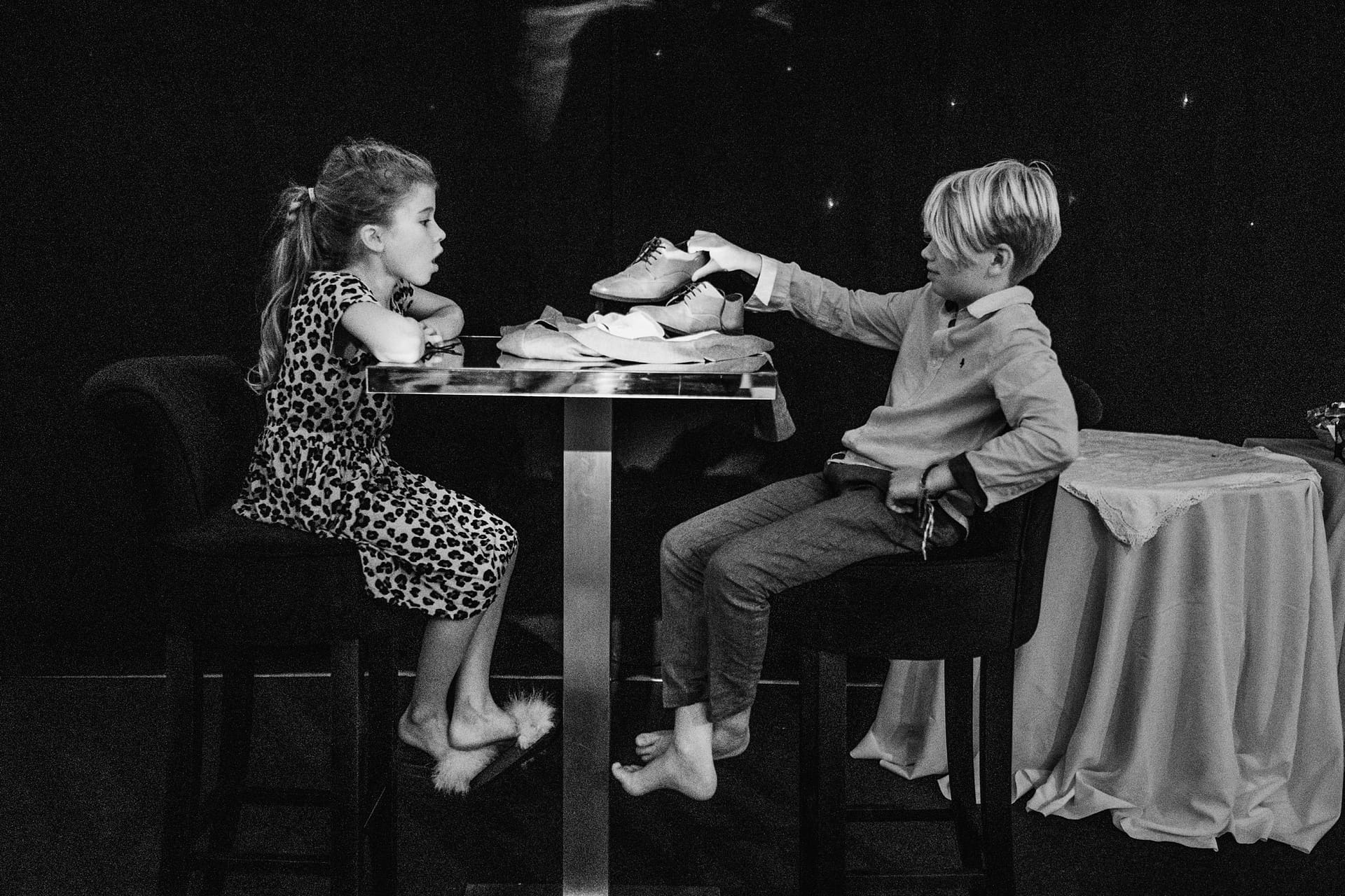 children sitting on stools next to dance floor
