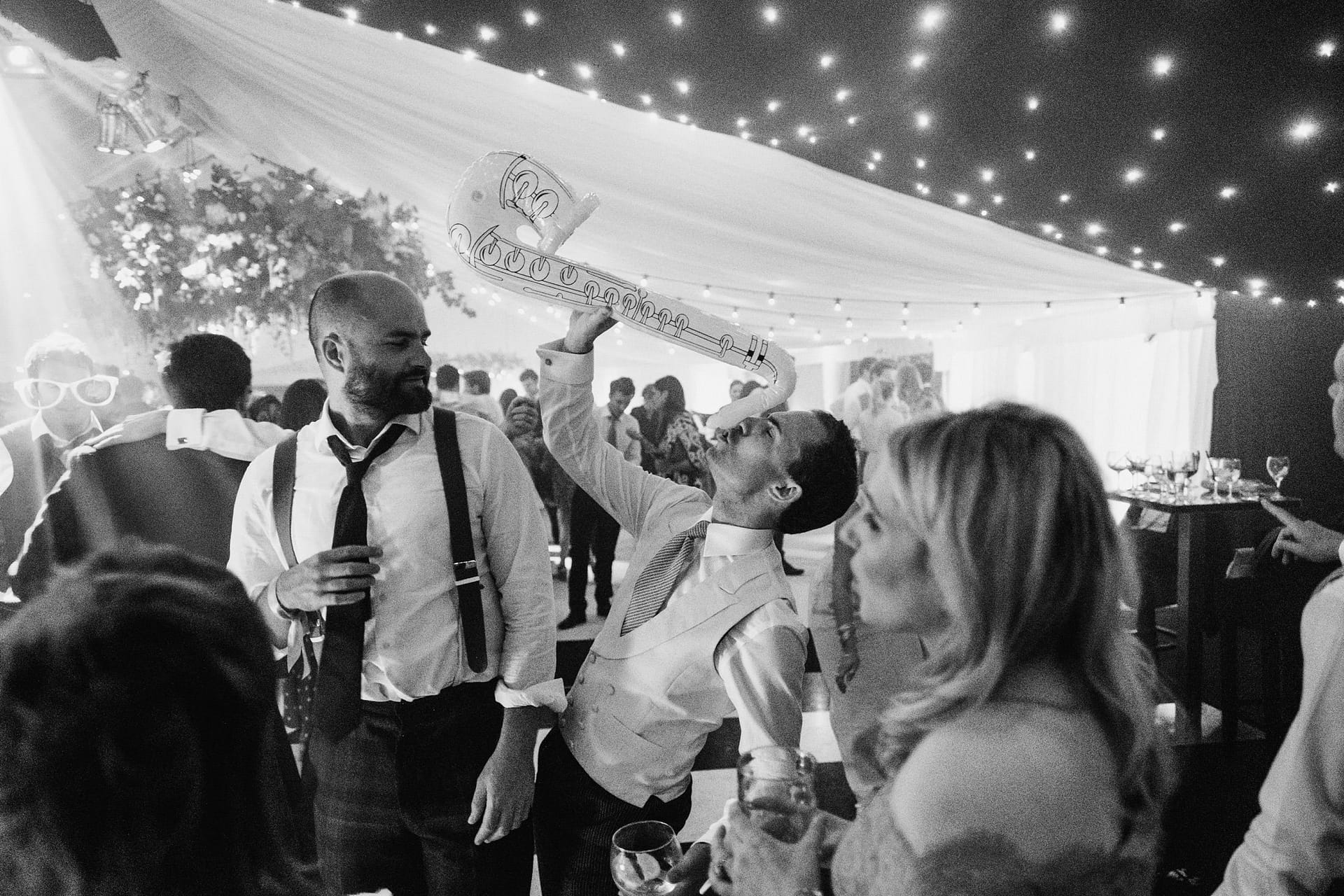 wedding guest on dance floor with blow up instruments