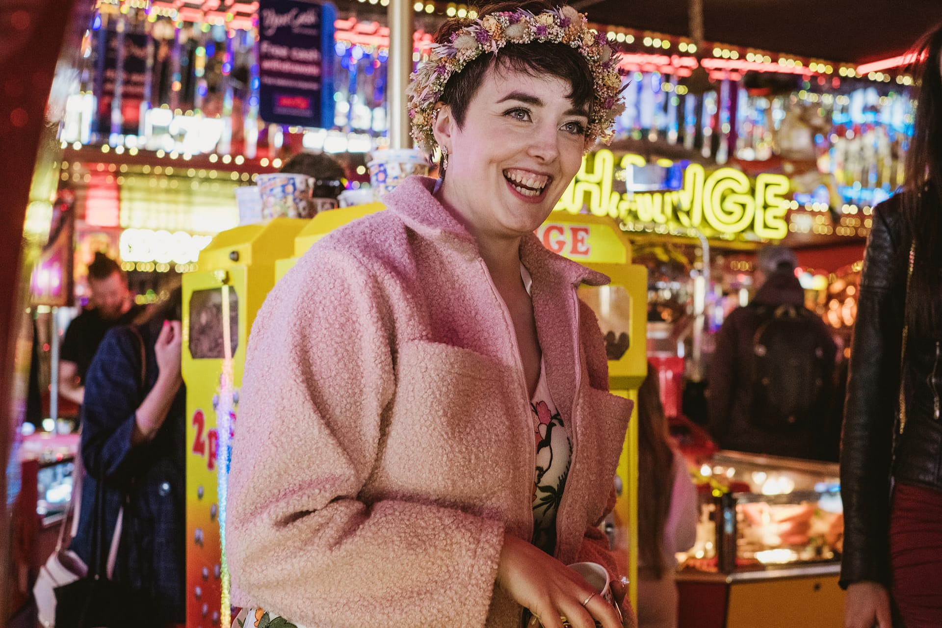 Person laughing in a decorated amusement arcade in Scarborough, North Yorkshire