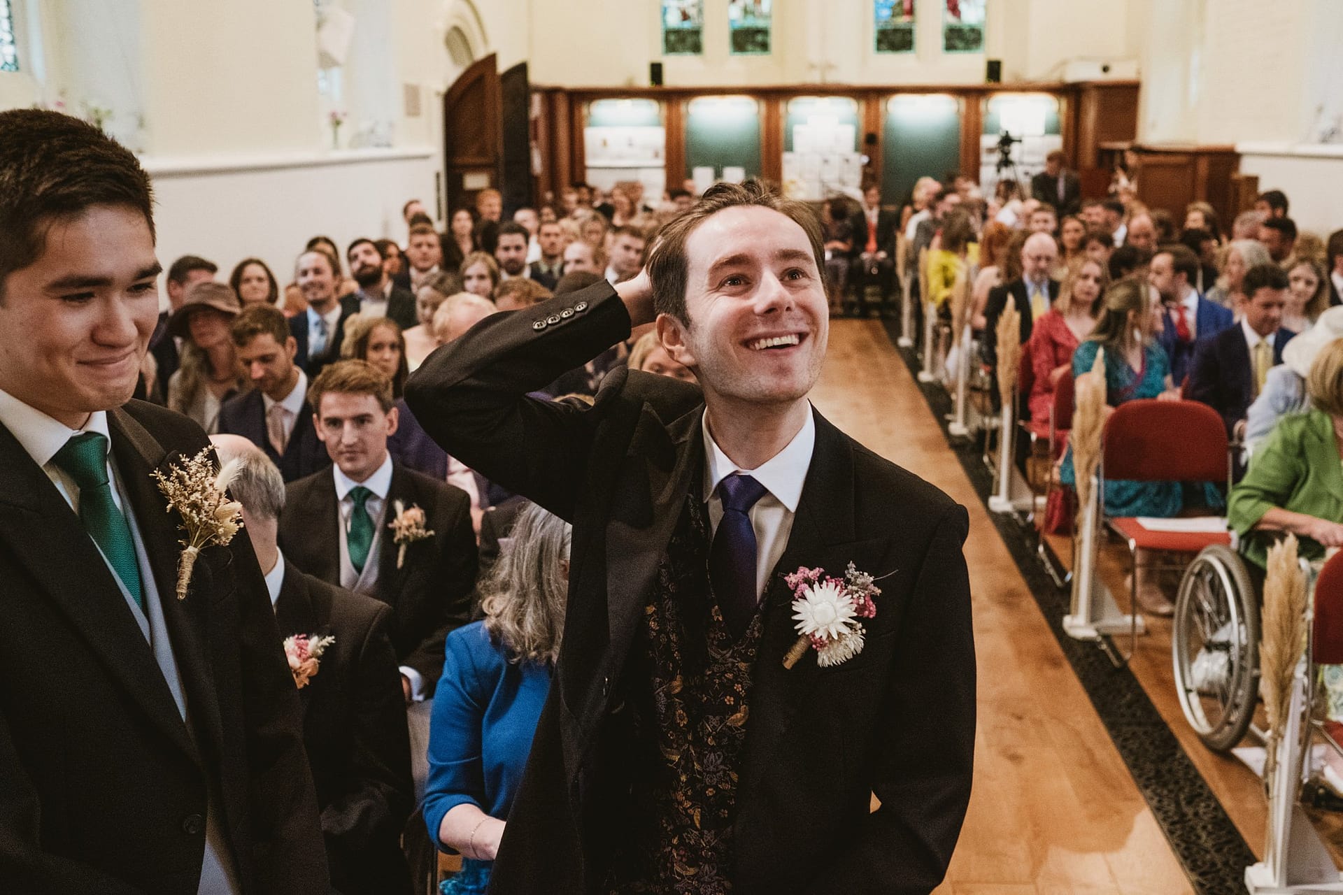 groom waiting for bride to come into the church in surrey