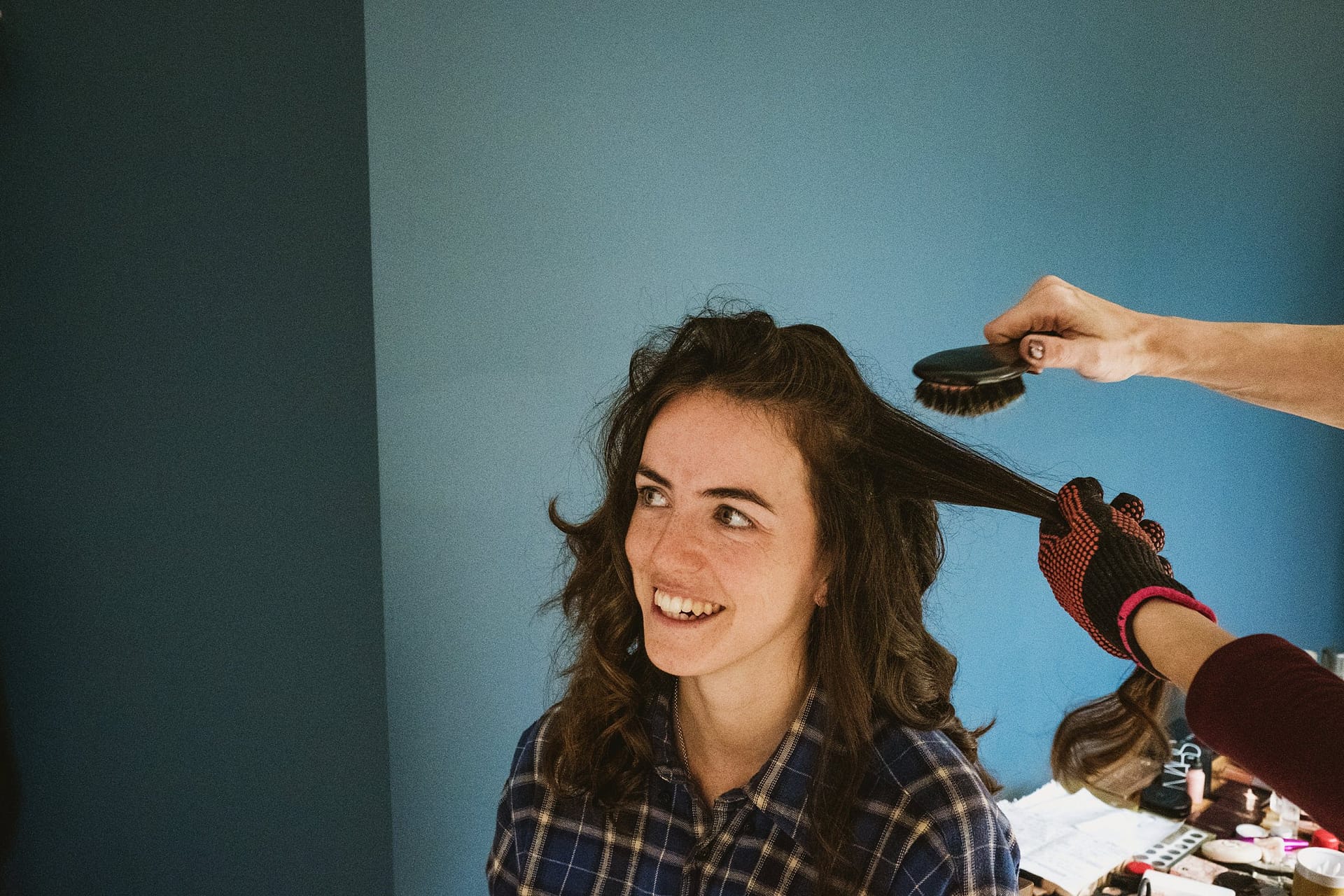bride having her hair done in her family home in Surrey