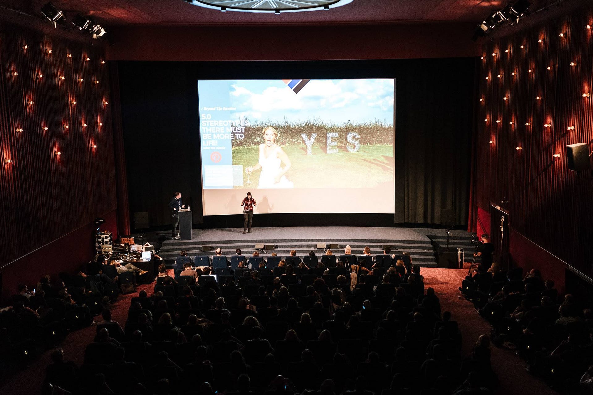 Photographers Dominique Shaw & Liam Shaw (York Place Studios) speak on stage at a photography conference in Berlin
