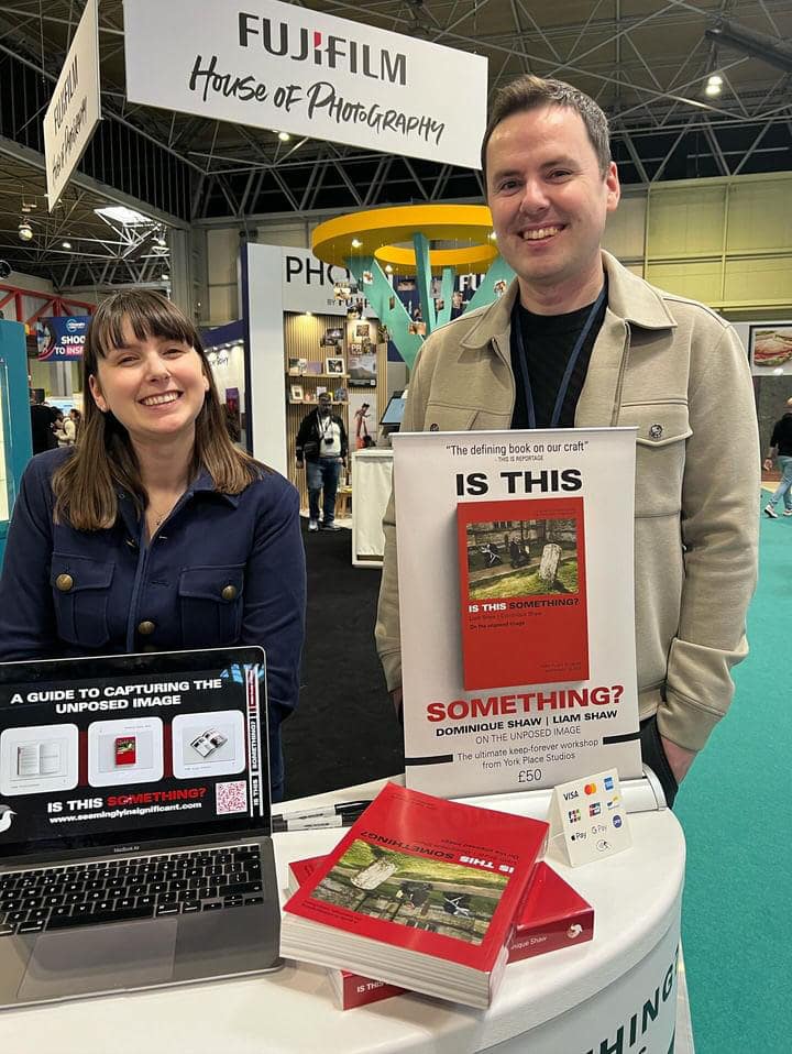dominique and liam selling their book is this something at a fujifilm event