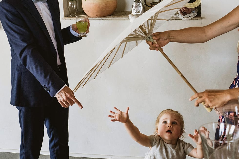 child reaching for sun umbrella at krakow wedding