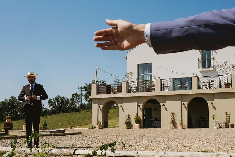 Stylised wedding photograph of groom outside Villa Love