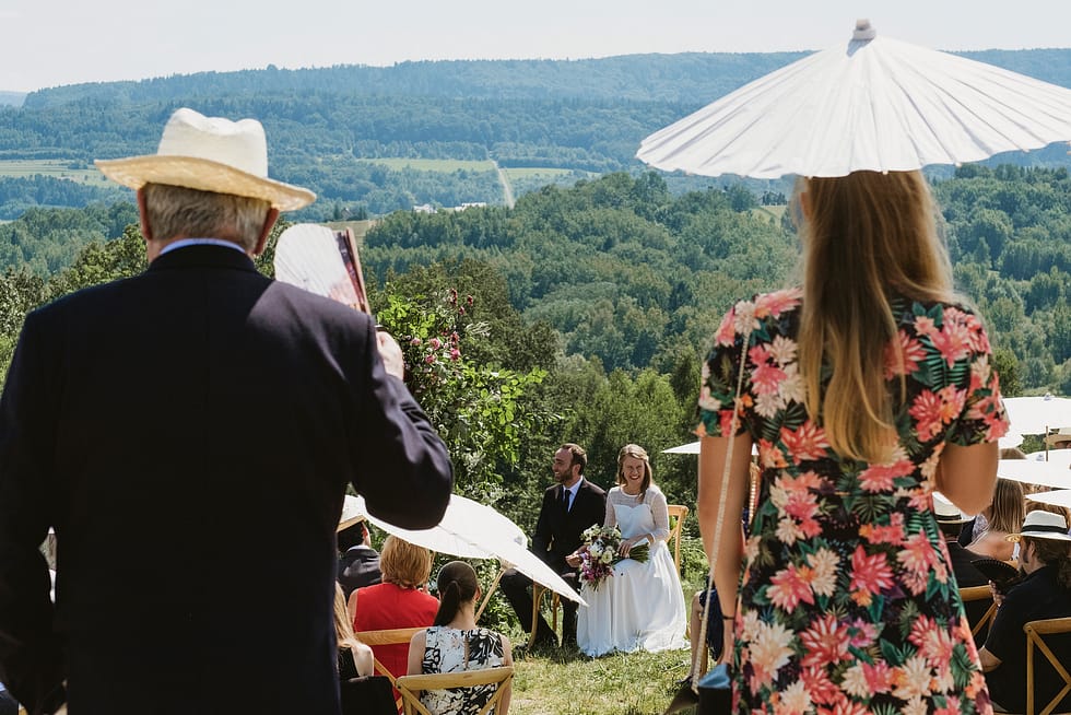 Bride and groom framed by guests