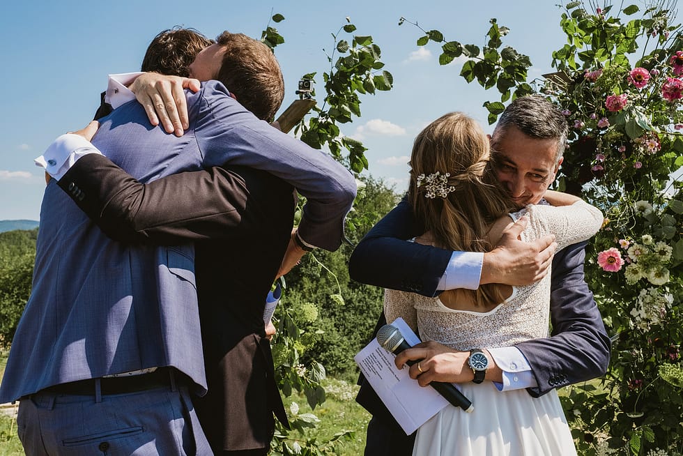 Bride and groom hugs after readings at Villa Love wedding ceremony