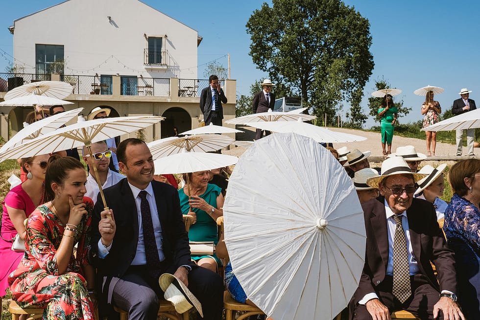 Photograph of guests during ceremony outside Villa Love