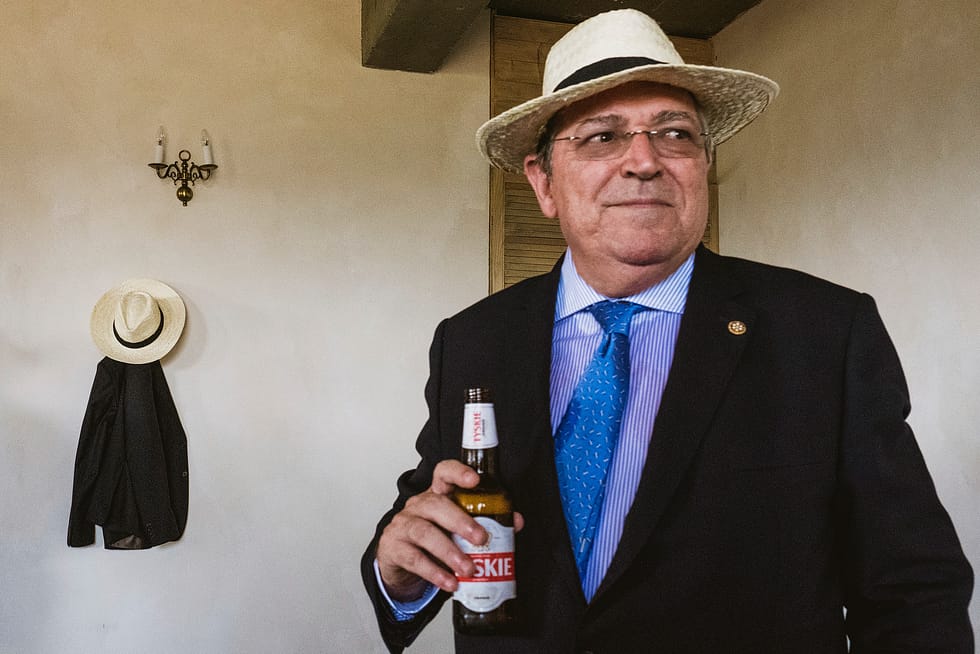 Wedding guest with beer wearing Polish straw hat