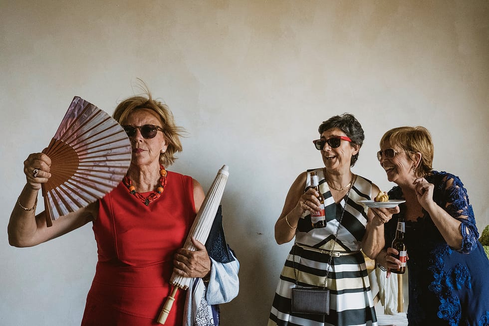 Female wedding guests with fan